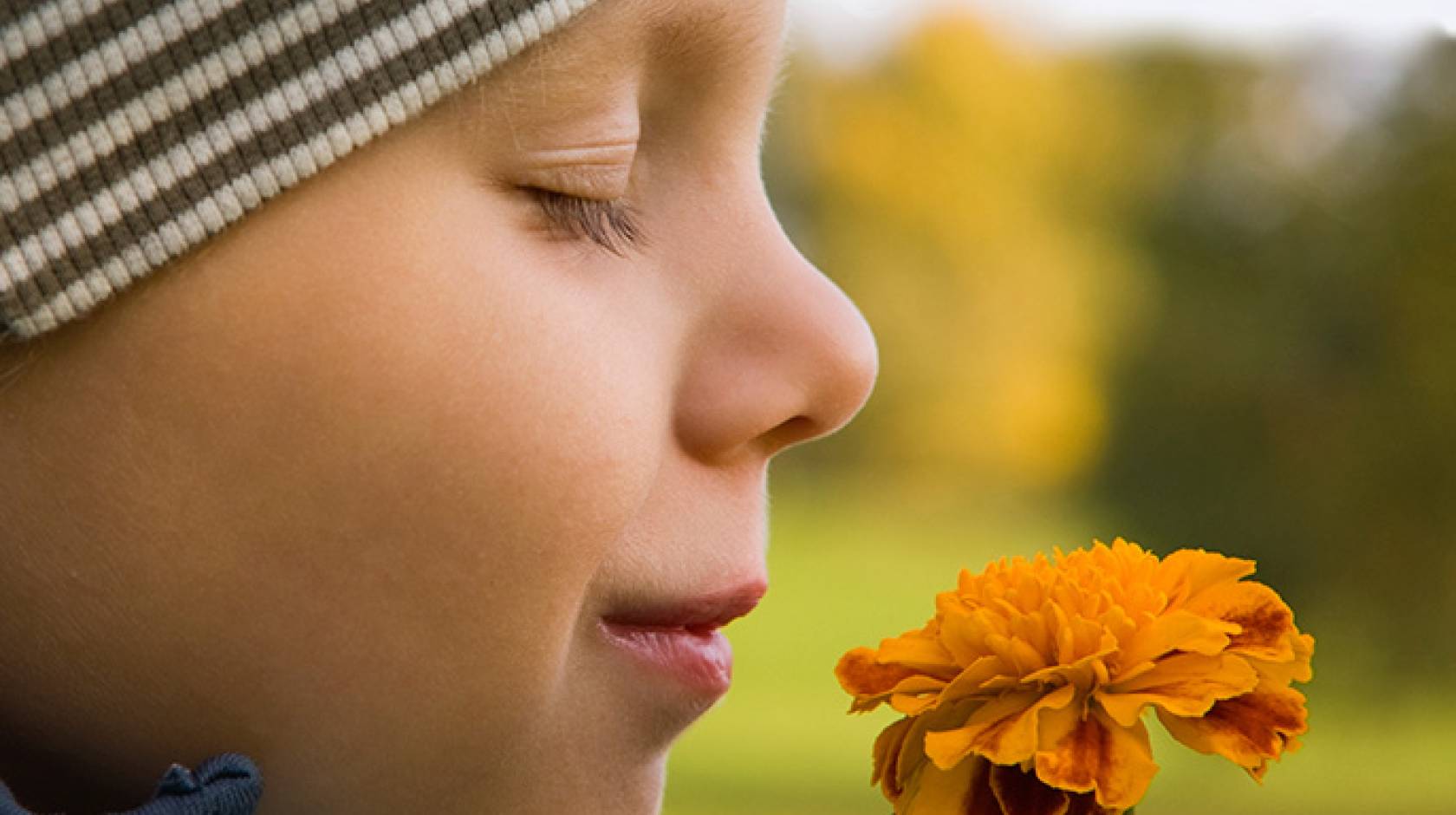 boy smells flower