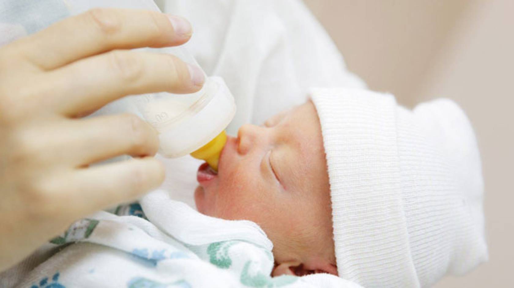 an infant feeding from formula