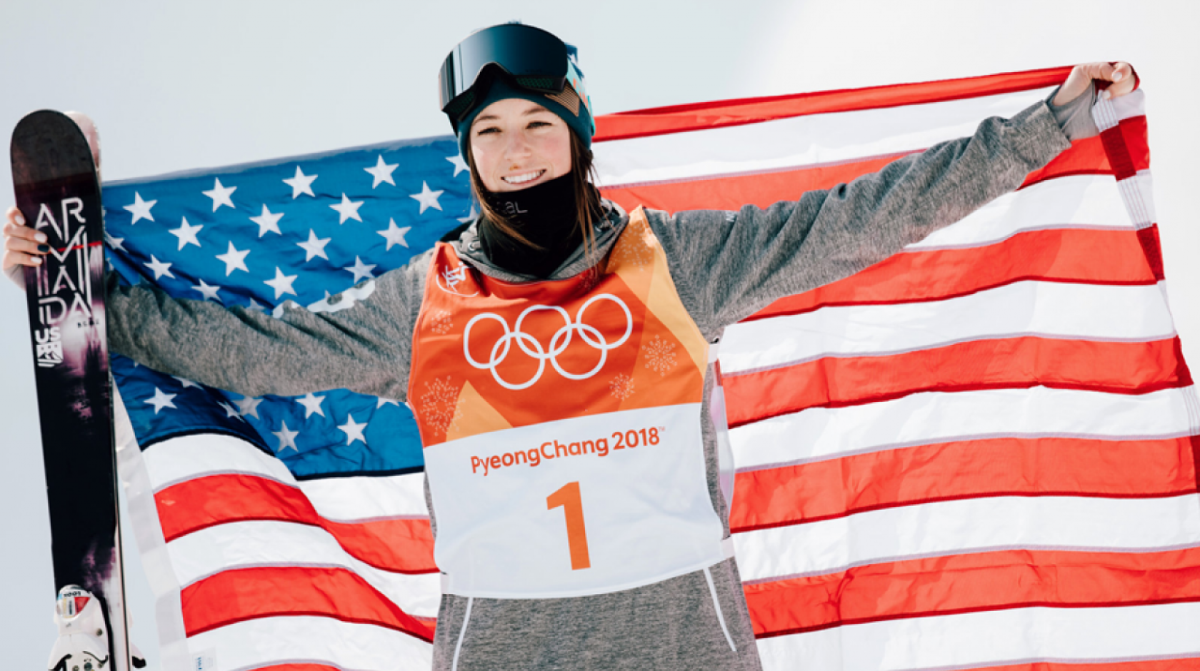 Brita Sigourney holds the U.S. flag after a medal-winning run in 2018
