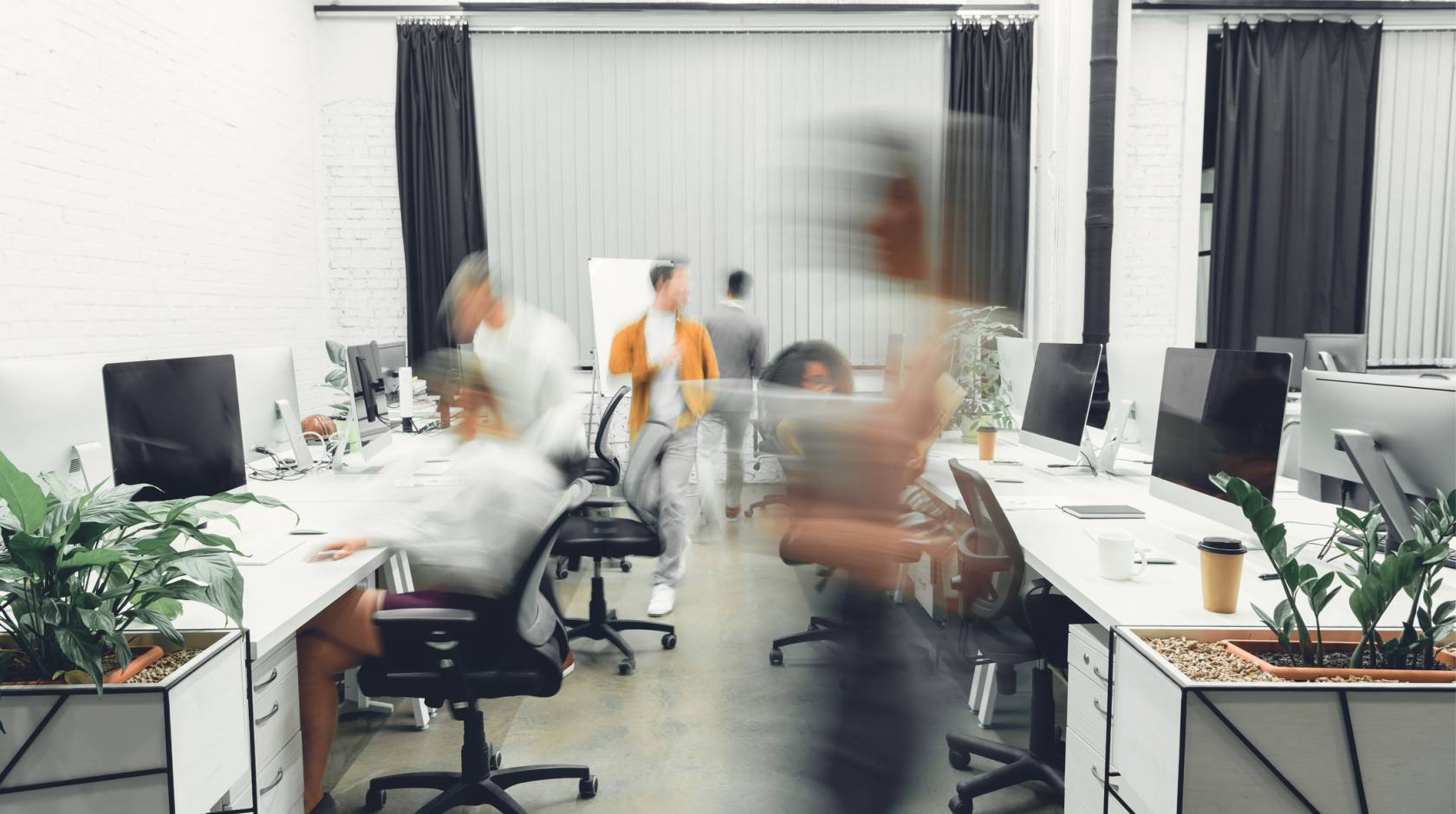 contemporary open space office interior with blurred coworkers in motion