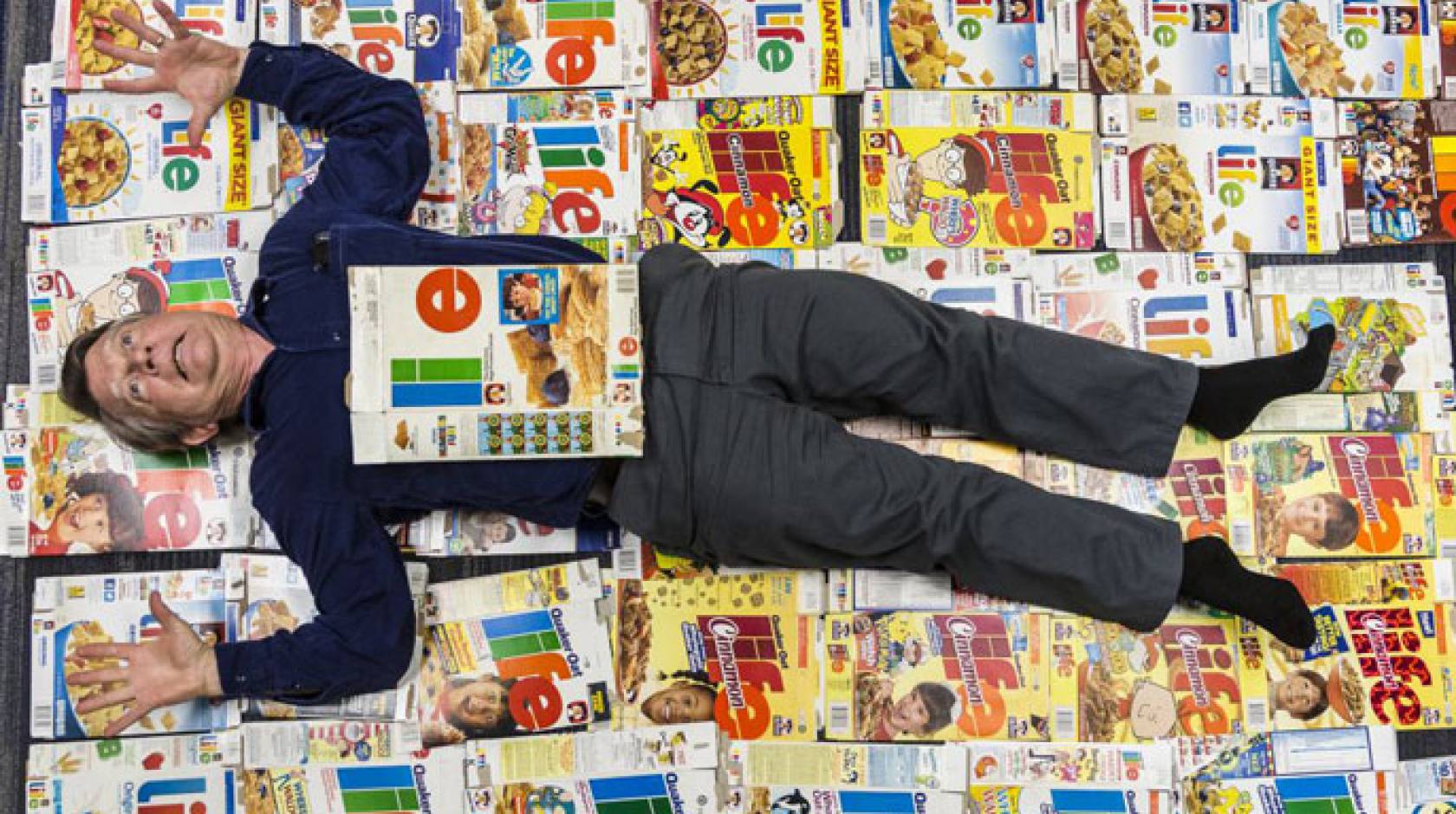 Professor lying on top of cereal boxes