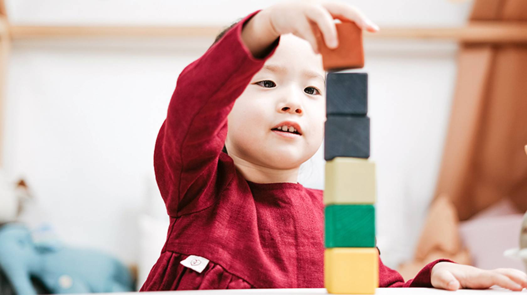 Young child playing with blocks in a classroom