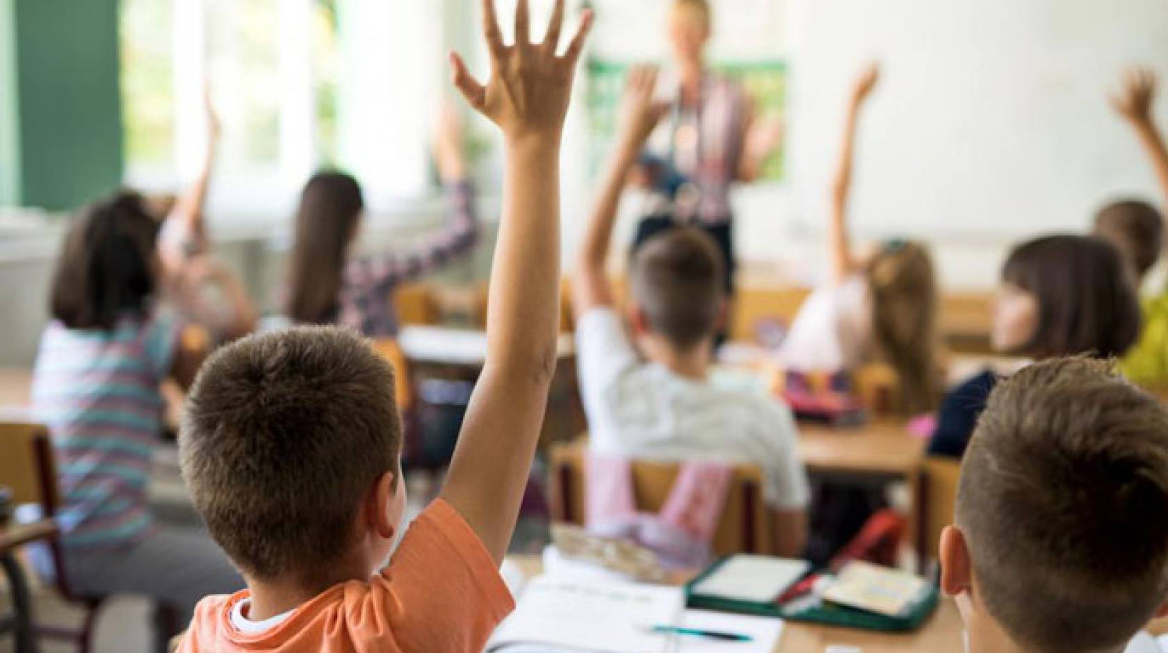 Children raising their hands