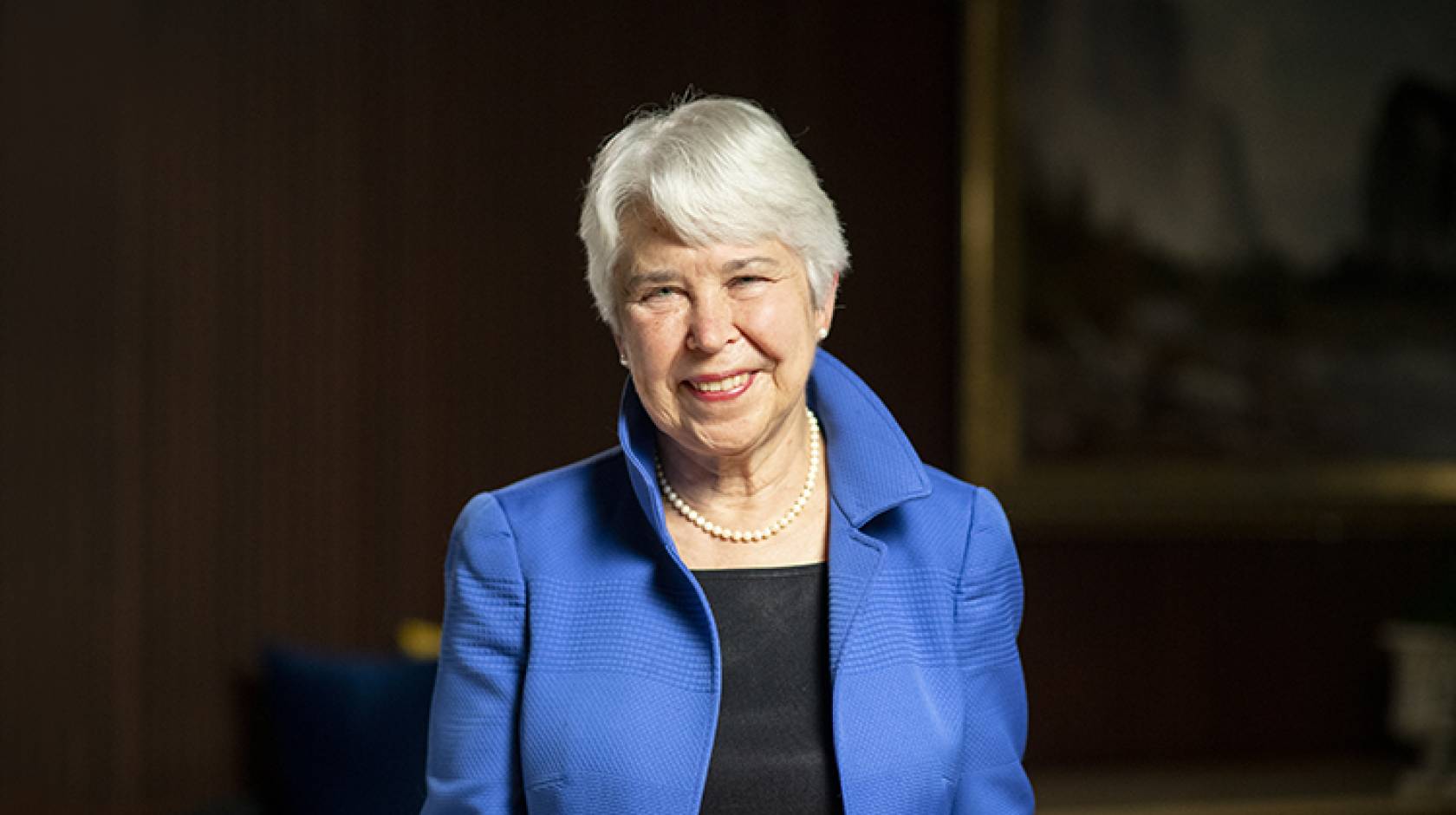 UC Berkeley Chancellor Carol Christ, smiling woman with short white hair, in blue jacket