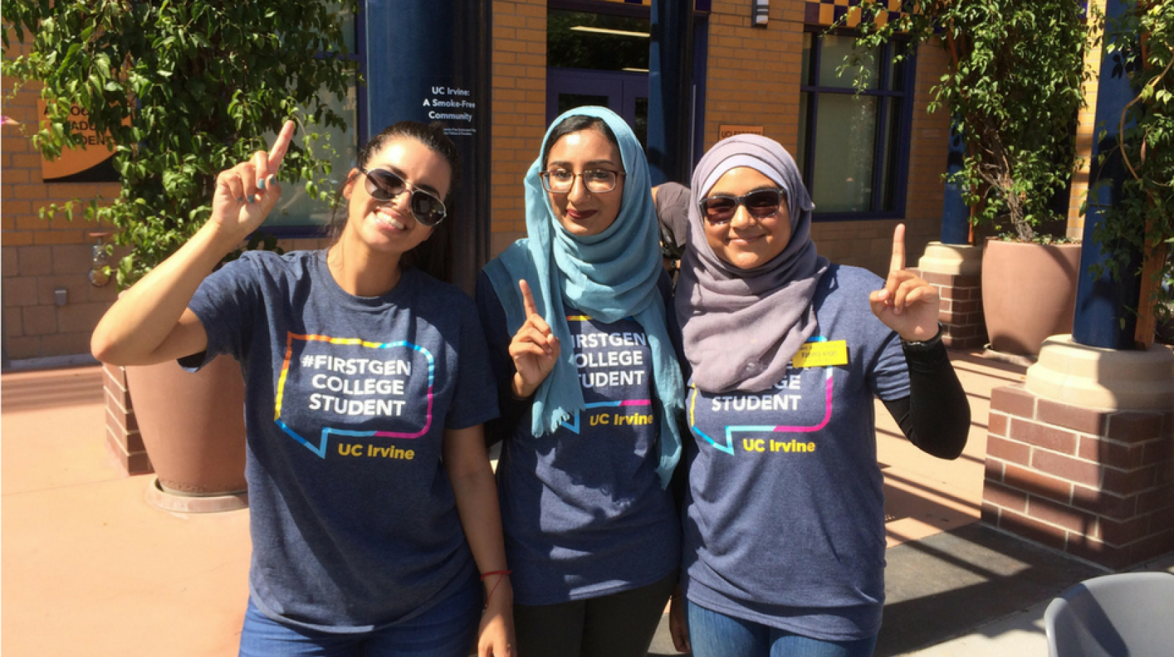 First-gen students pose for picture in first-gen T-shirts