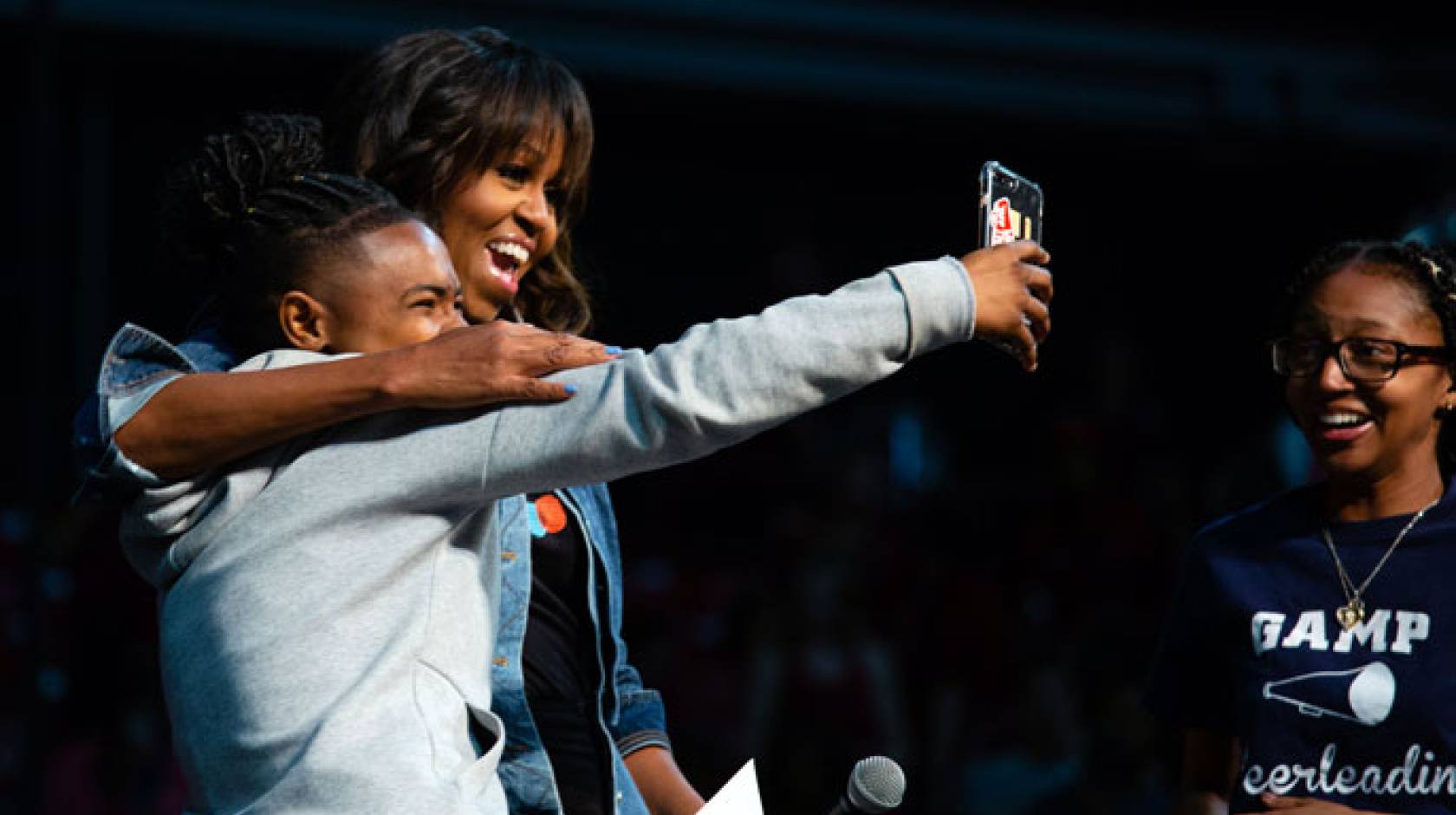 Michelle Obama takes a selfie with a student on College Signing Day