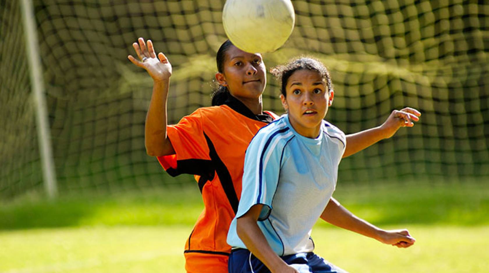 teen girls playing soccer