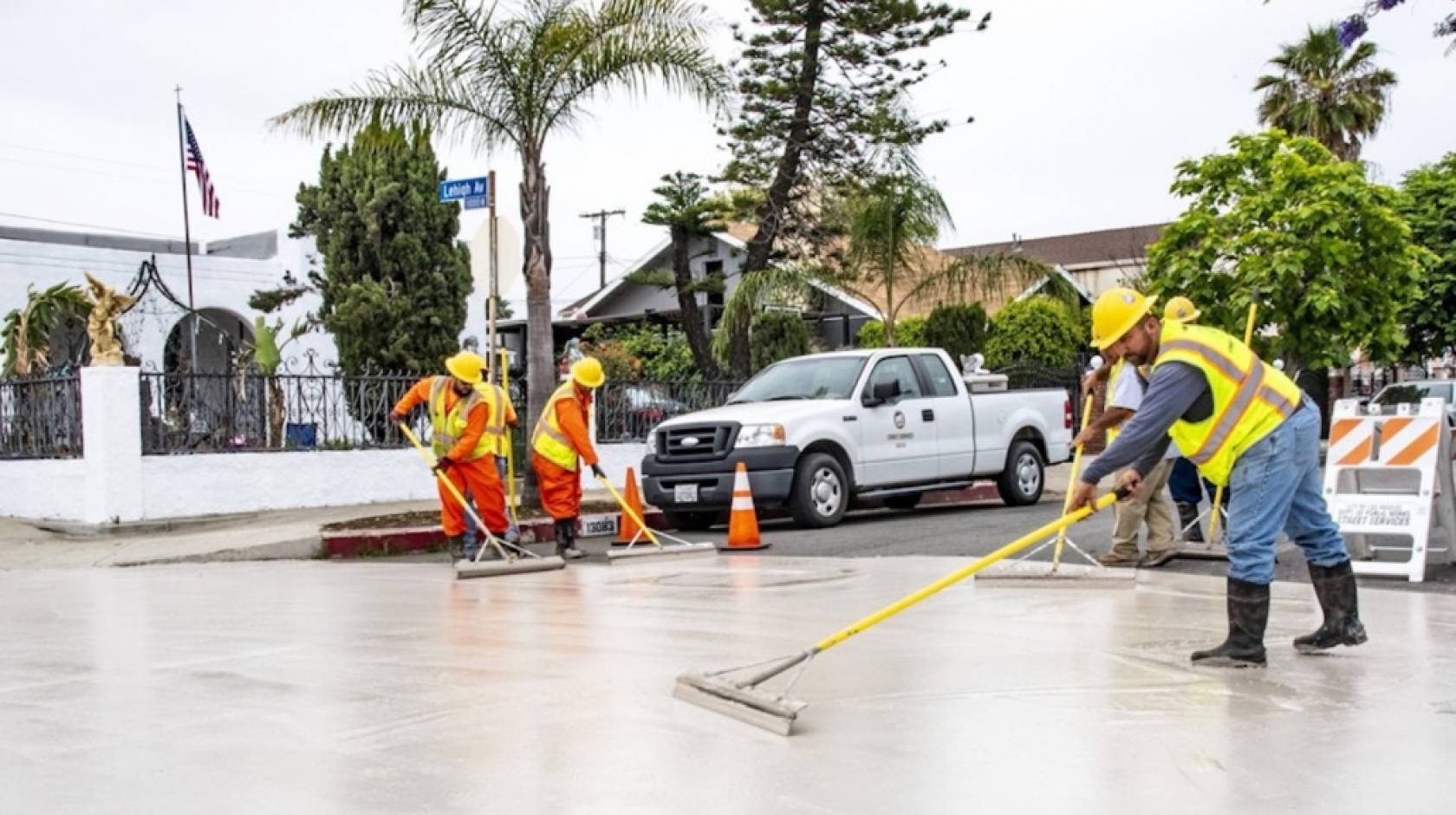 Workers applying cool pavement