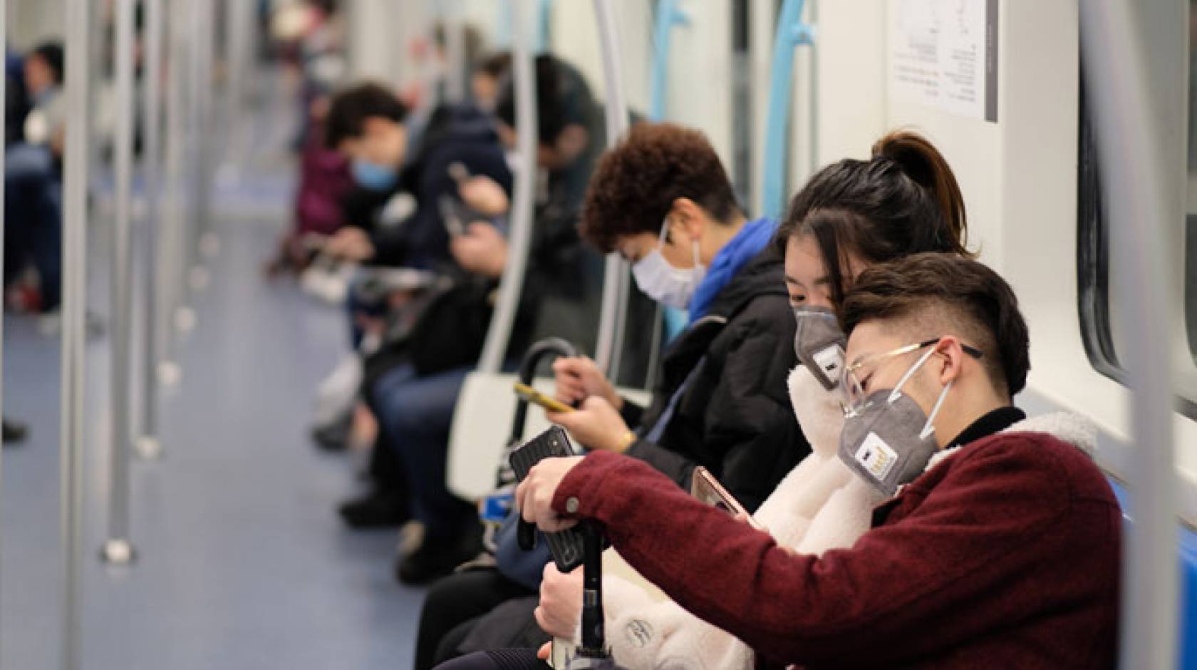 People on a subway with surgical masks on in China