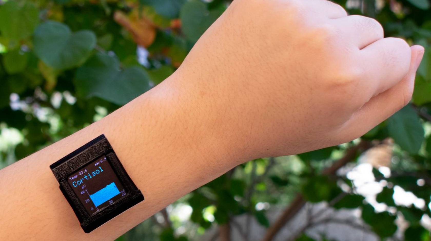 A smart watch on a wrist with cortisol reading displayed