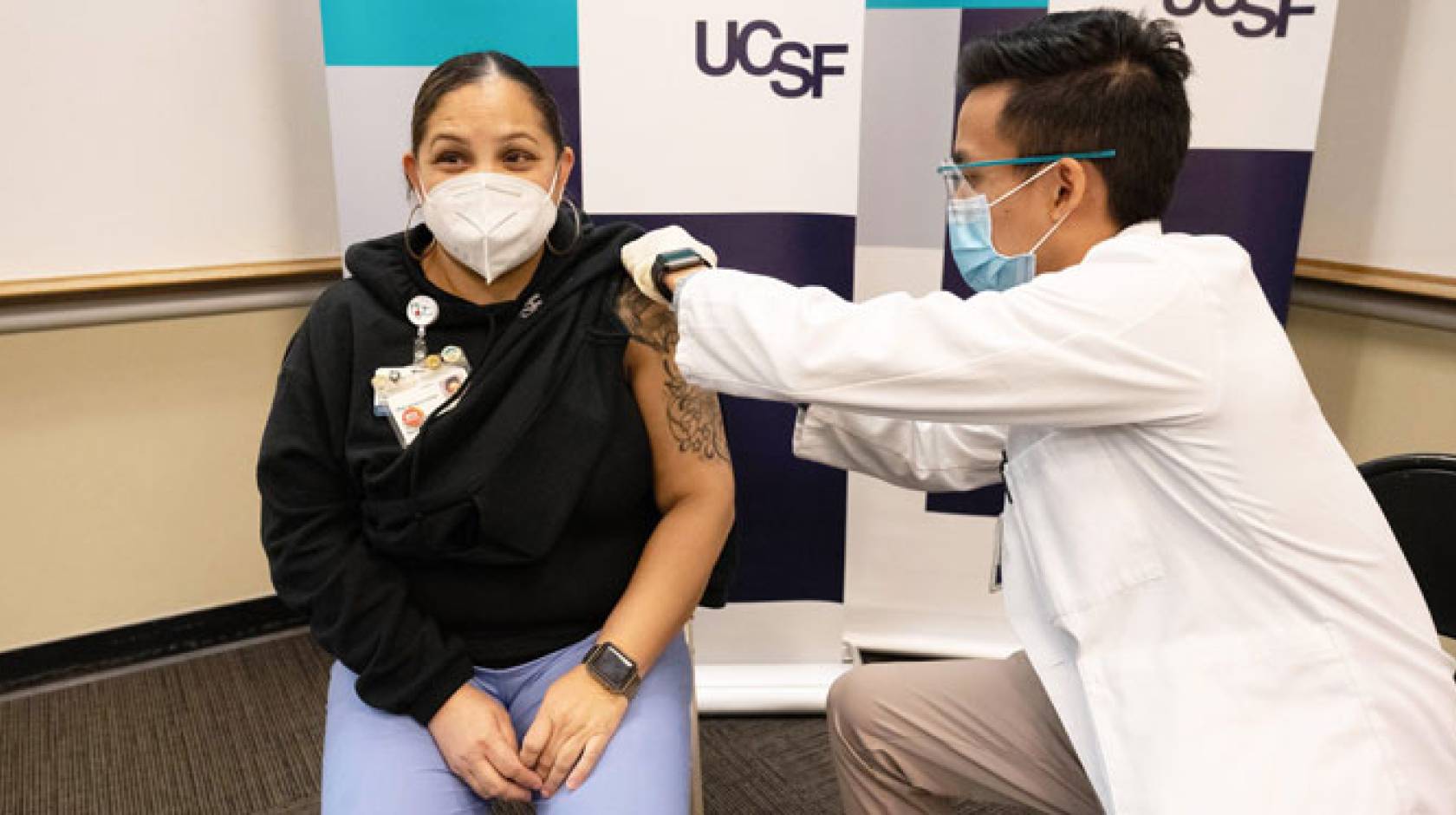 Woman happily getting COVID-19 vaccine