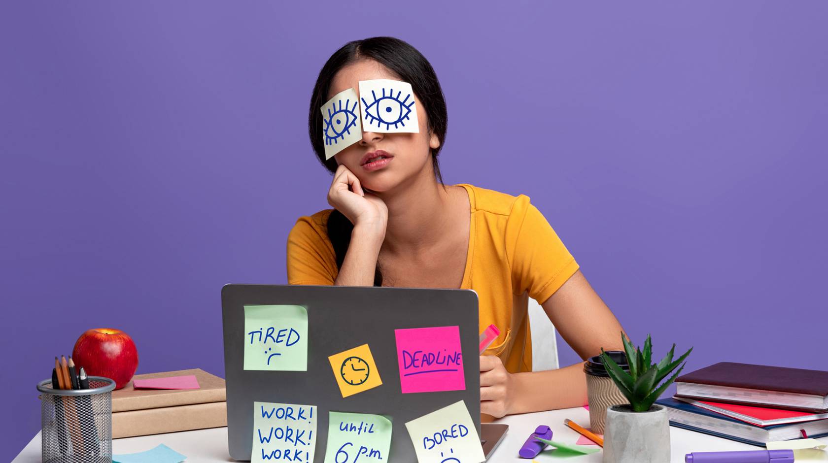 Woman with paper eyes showing her eyes open and a lot of post-its on her laptop reading Tired, Deadline, Work Work Work Until 6 p.m. and Bored