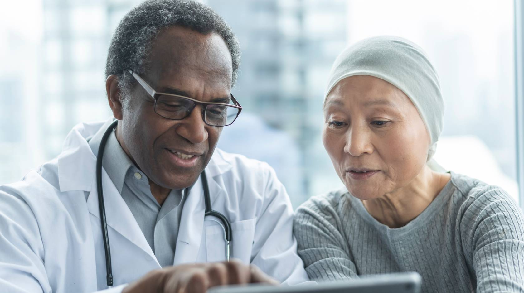 A doctor and a patient look at a screen together
