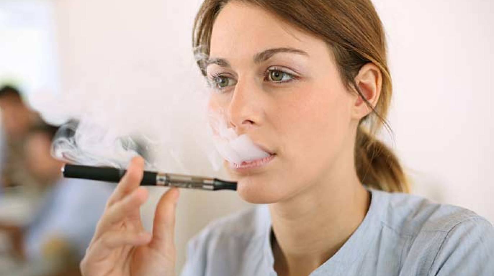 woman smoking e-cigarette