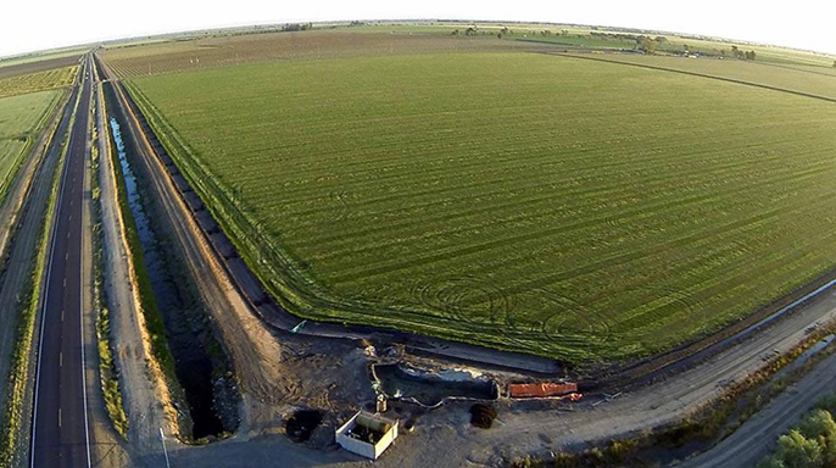 The upcoming climate-smart ag seminar will include discussions of California's elaborate water-delivery system, part of which is depicted in this photo of a Merced County field with its water pumps and adjacent irrigation canal.