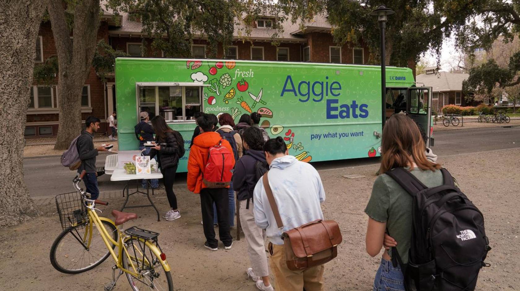 Aggie Eats food truck with students waiting in line