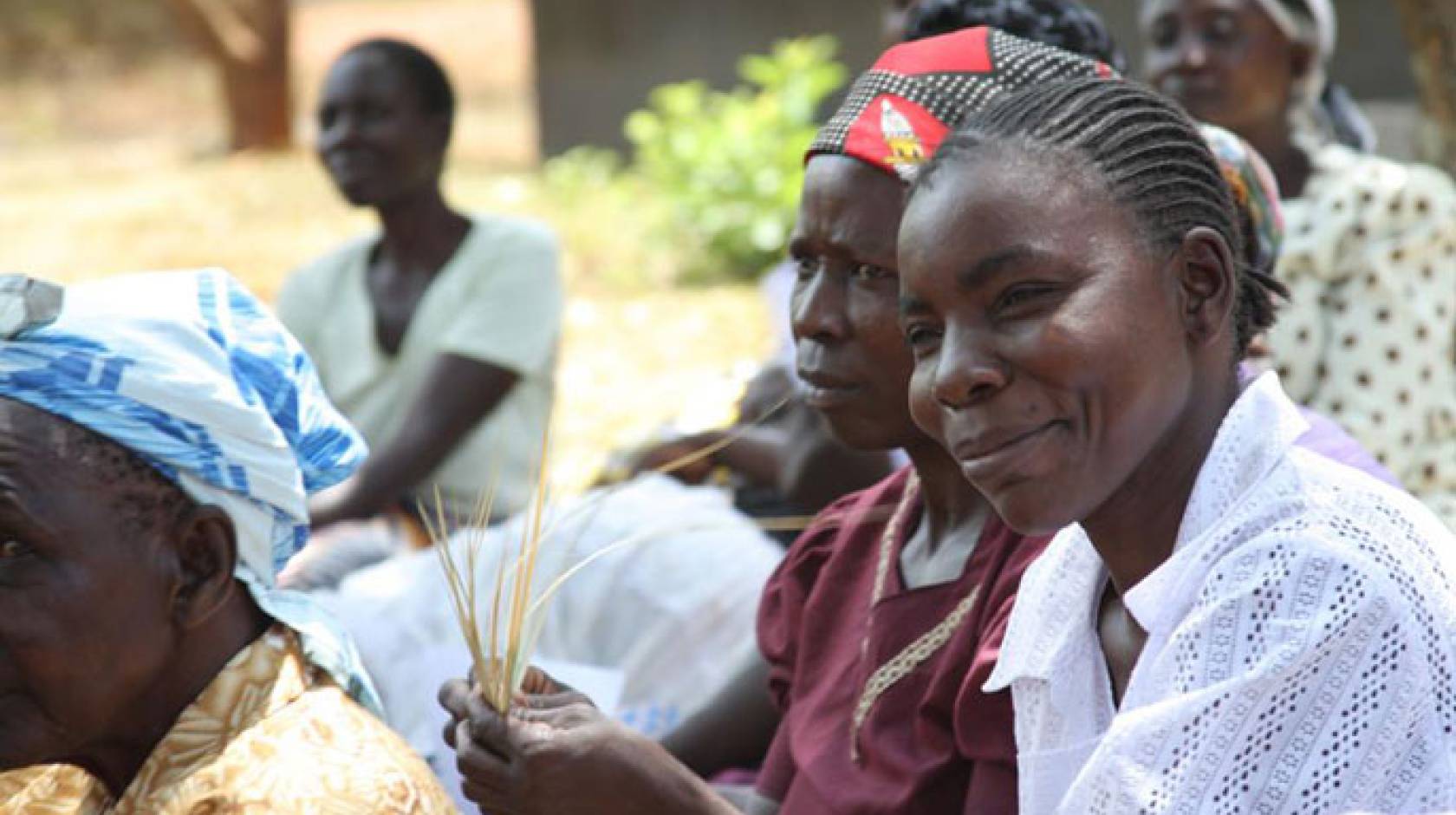 Women in western Kenya holding maize