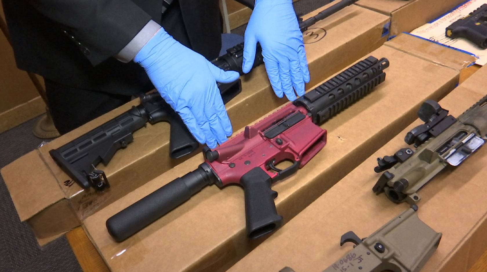 A San Franciso police officer displays several ‘ghost guns’ – untraceable firearms with no serial numbers or manufacturing marks. 