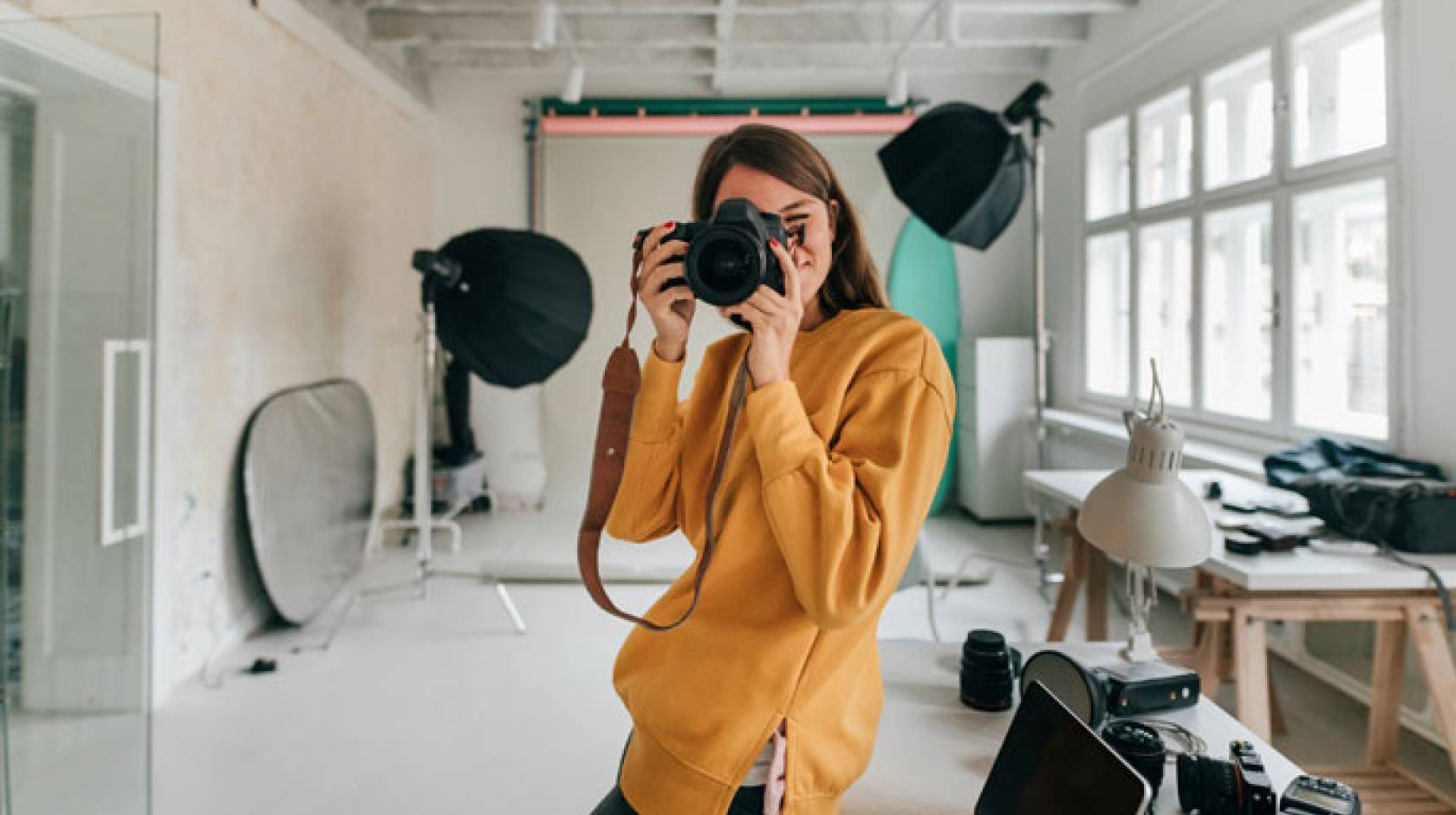 Photographer facing camera with a camera