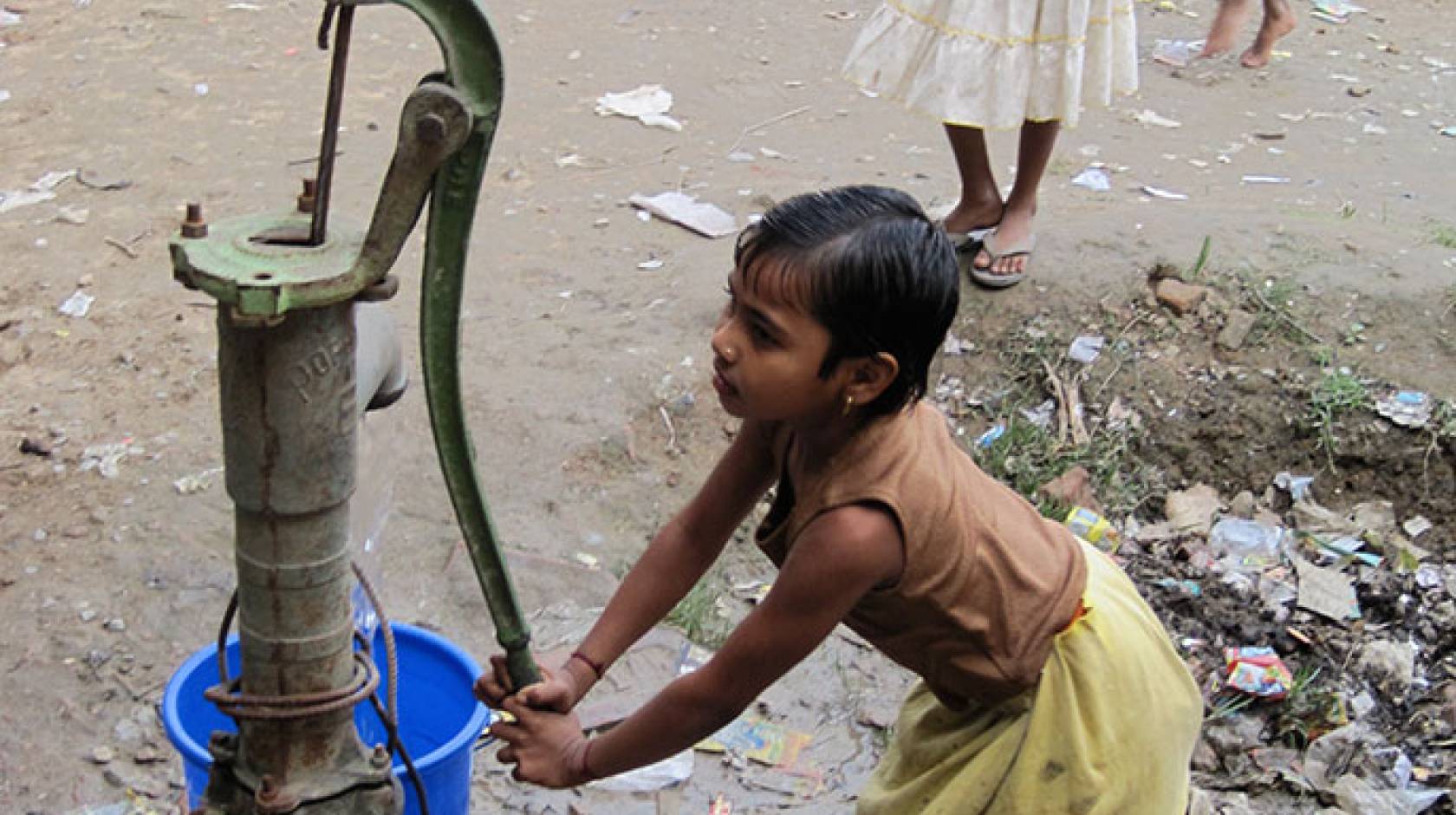 girl at water pump