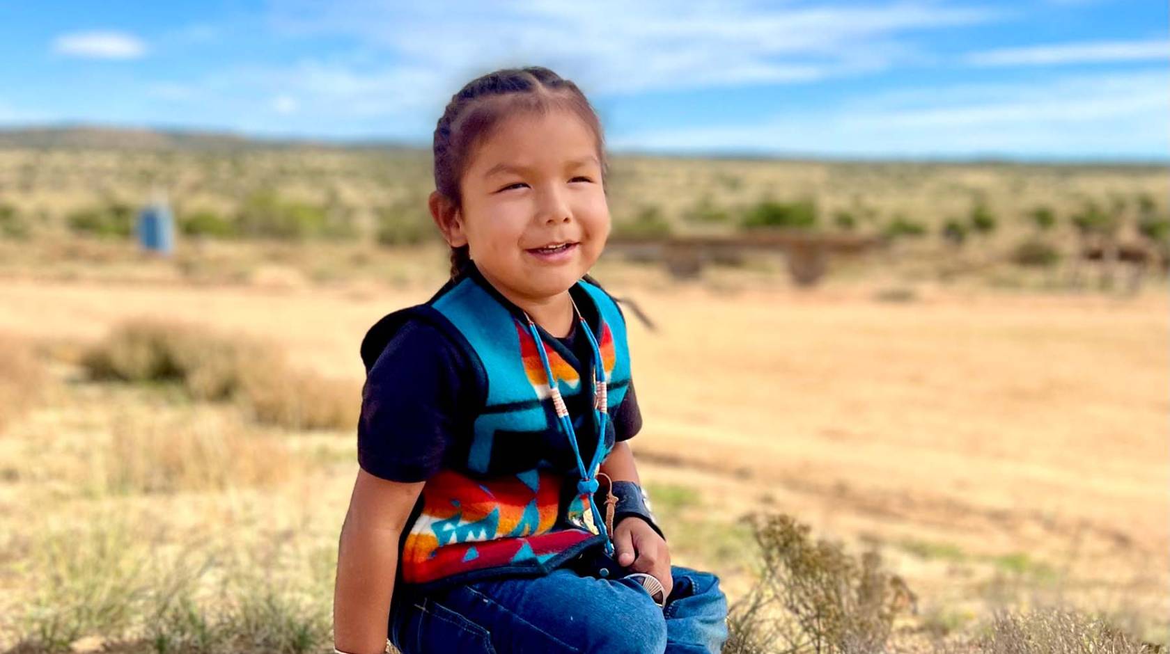 HT, a Navajo toddler, smiling at home