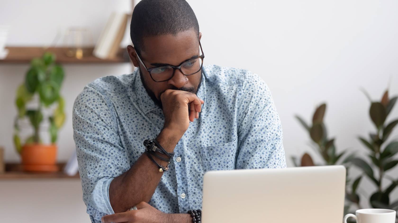 Man anxiously looks at his laptop