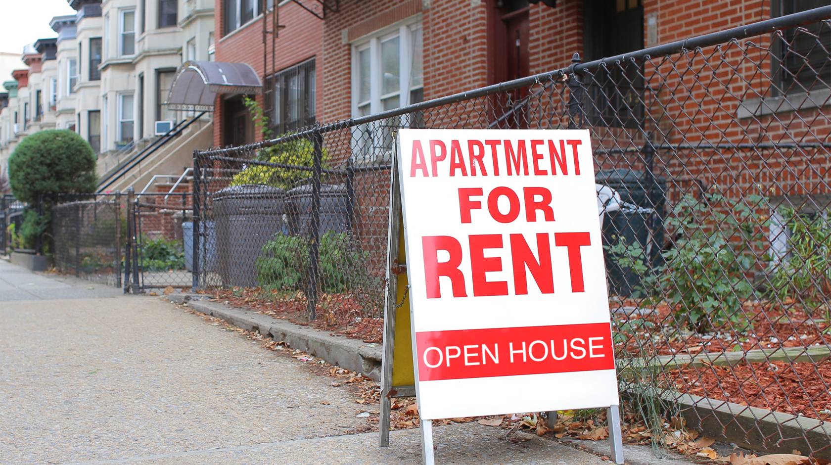 For rent sign in front of an apartment building