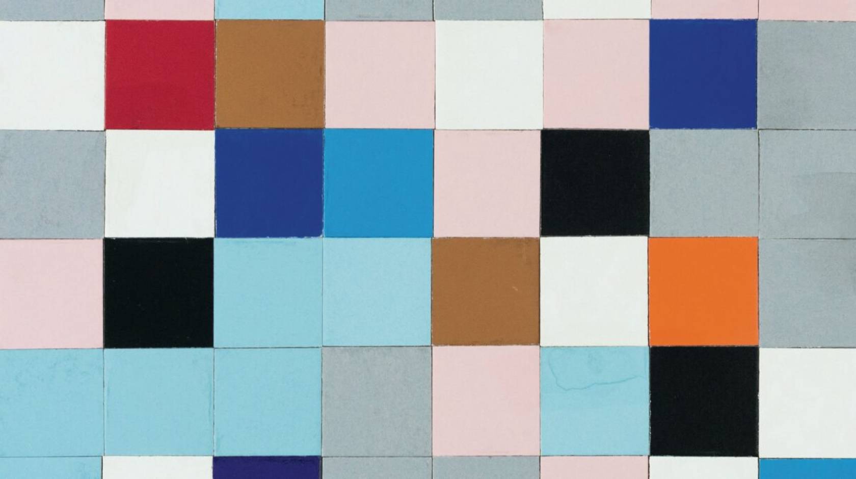 A grid of square tiles of different colors in a muted palette, in a seemingly random arrangement