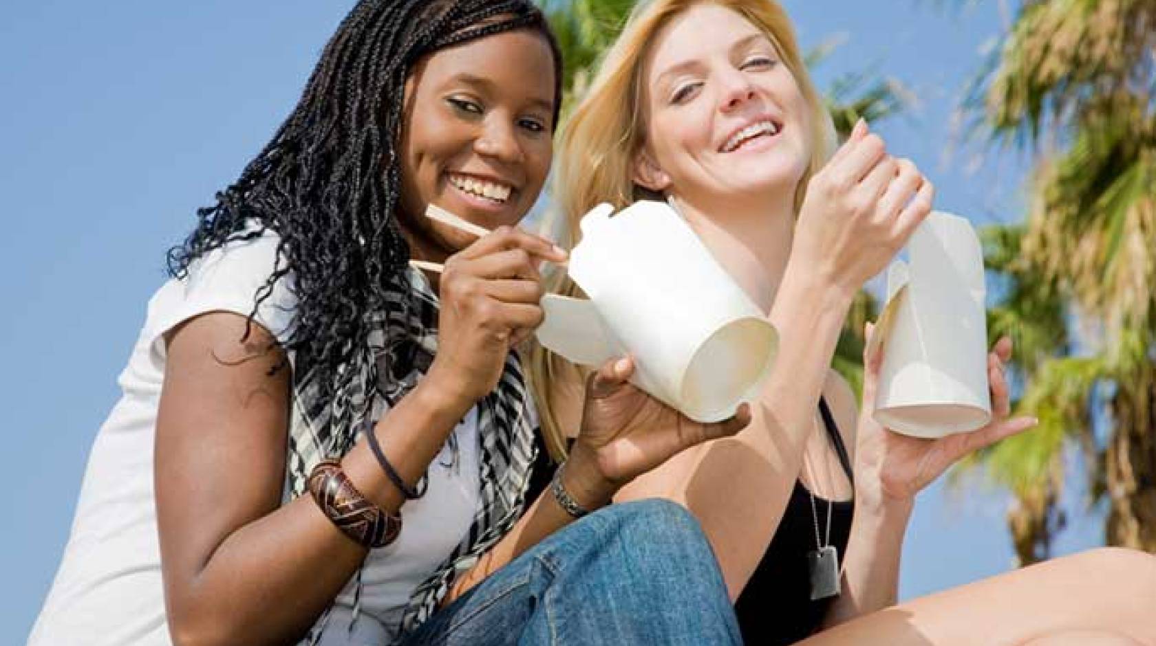 Young women eating Chinese takeout food (iStock)