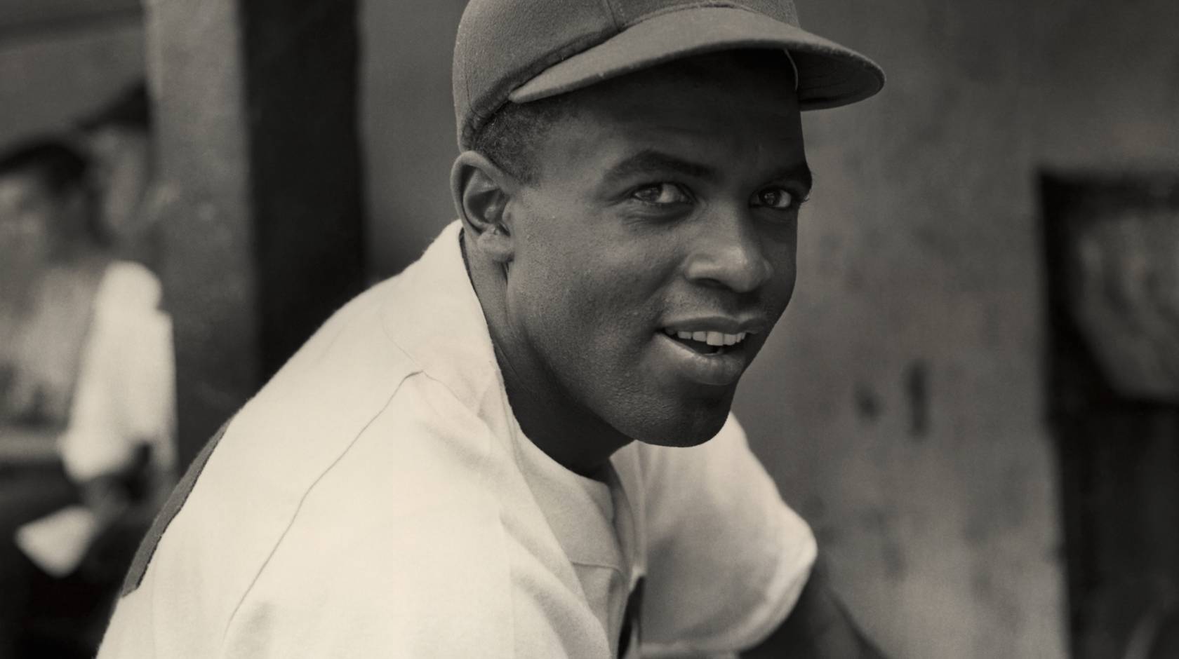 Jackie Robinson smiles in his Brooklyn Dodgers uniform
