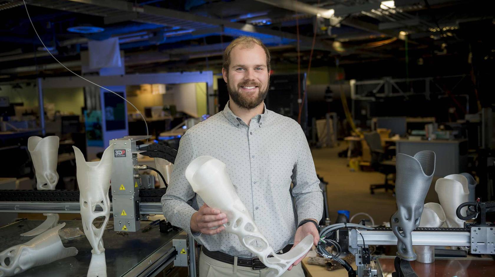 Joshua Pelz holding a 3D-printed prosthetic