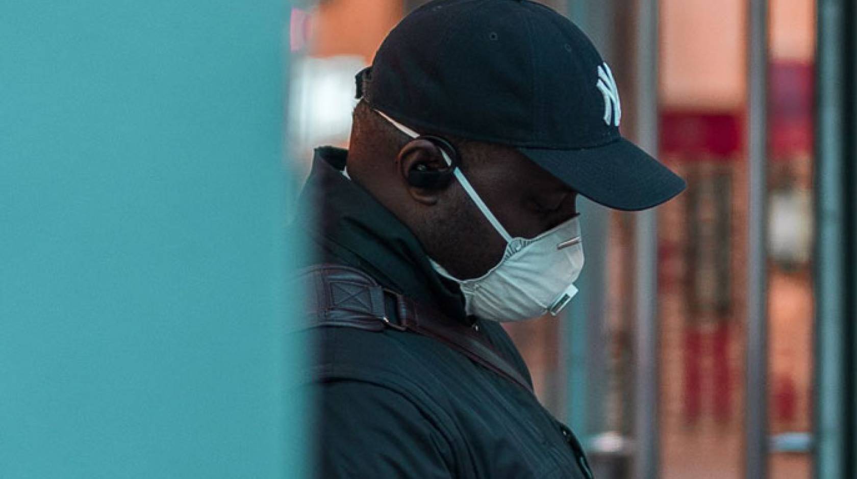 Black man wearing respirator mask outside