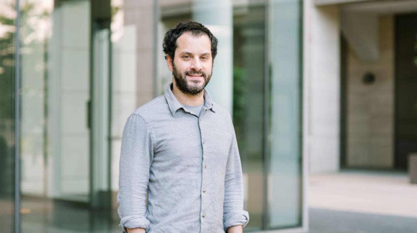 Mazen Kheirbek stands in front of a building