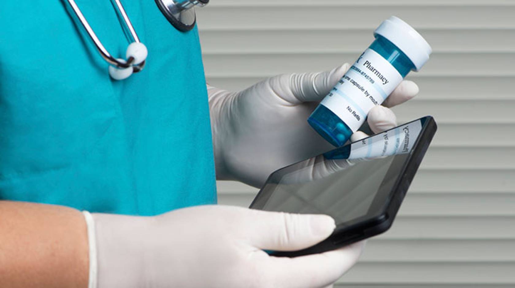 doctor holding iPad and medicine bottle