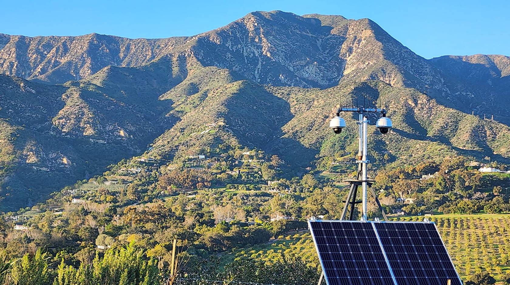 View of Ortega Ridge near Santa Barbara and cameras fitted with solar panels in the foreground