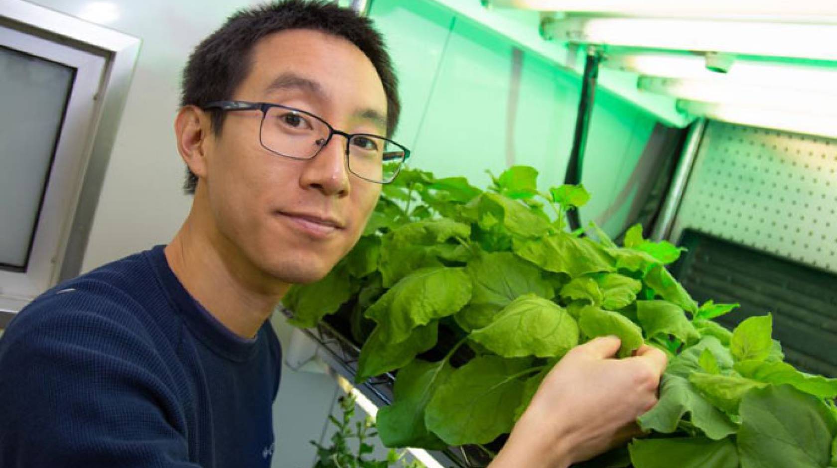 Patrick Shih in front of his plants