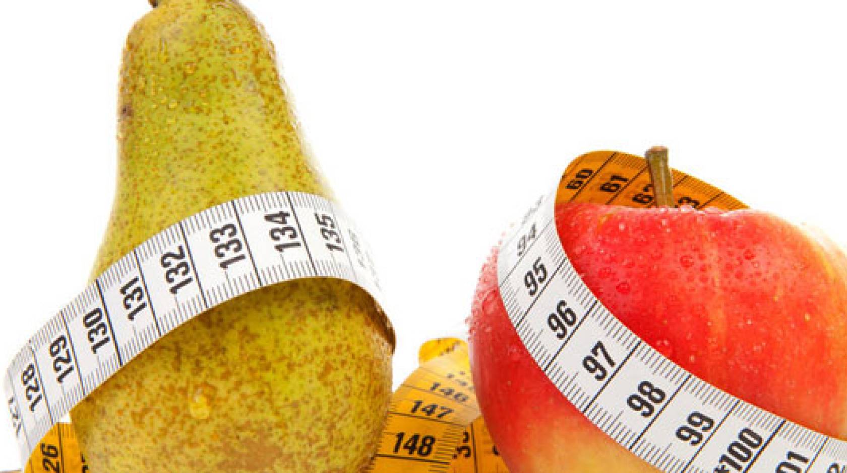 Pears and apples with measuring tape wrapped around them