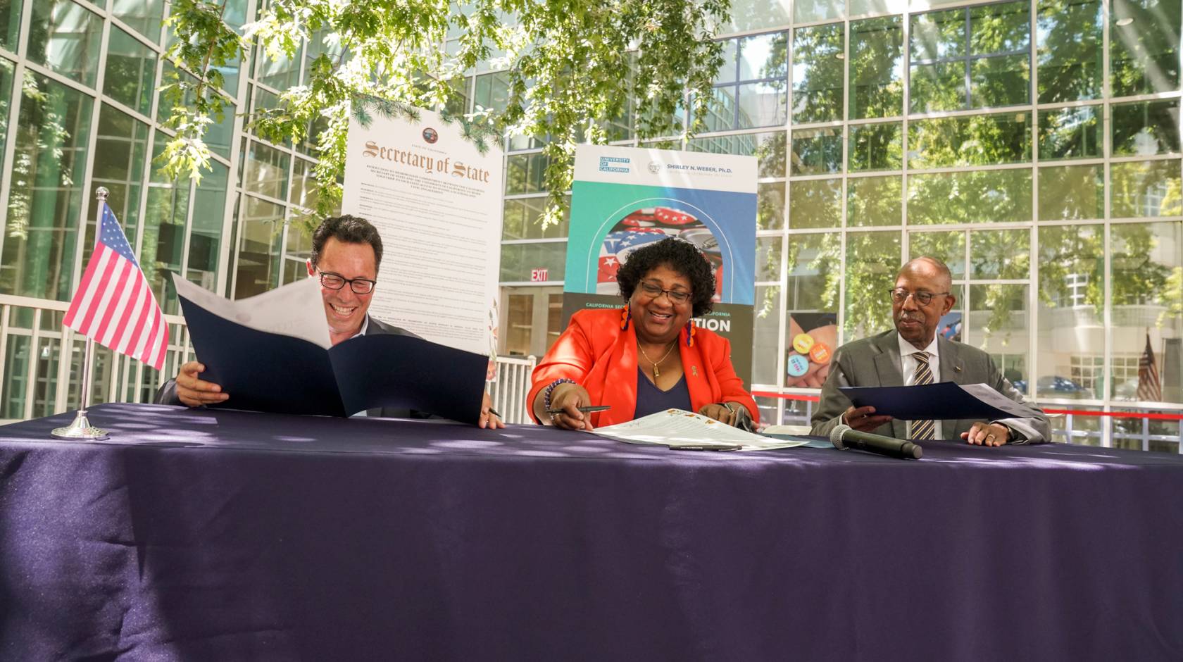 UC Board of Regents Vice Chair Leib, California Secretary of State Weber and UC President Drake sign voting resolution at UC Davis.