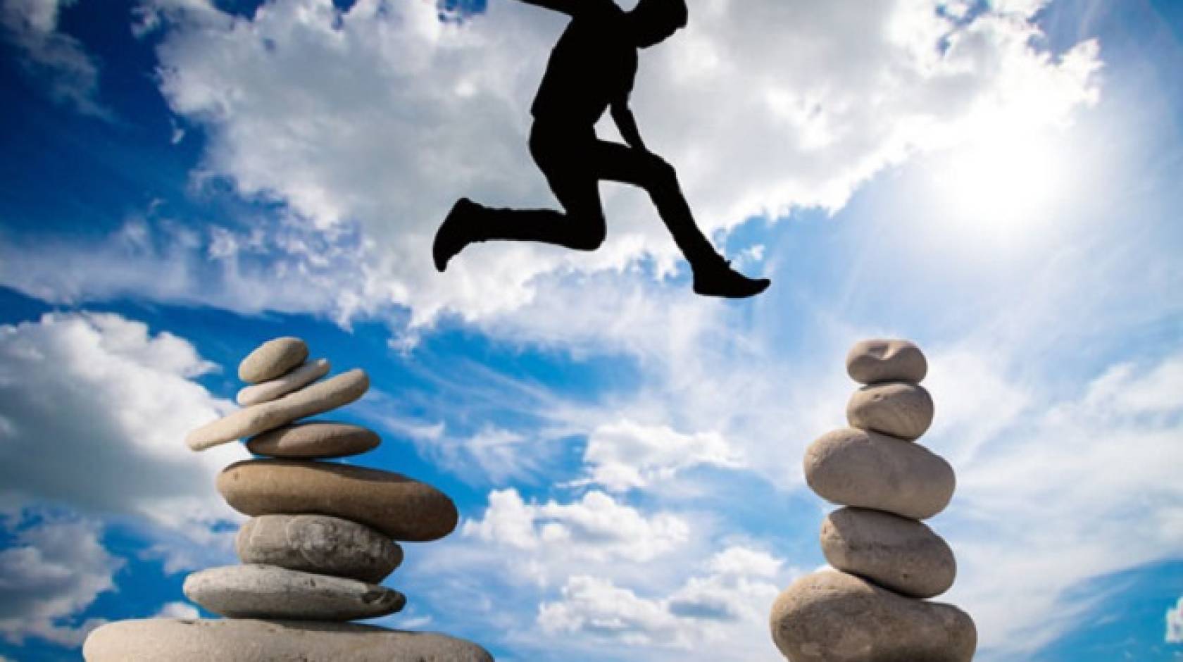 A man jumping over stones