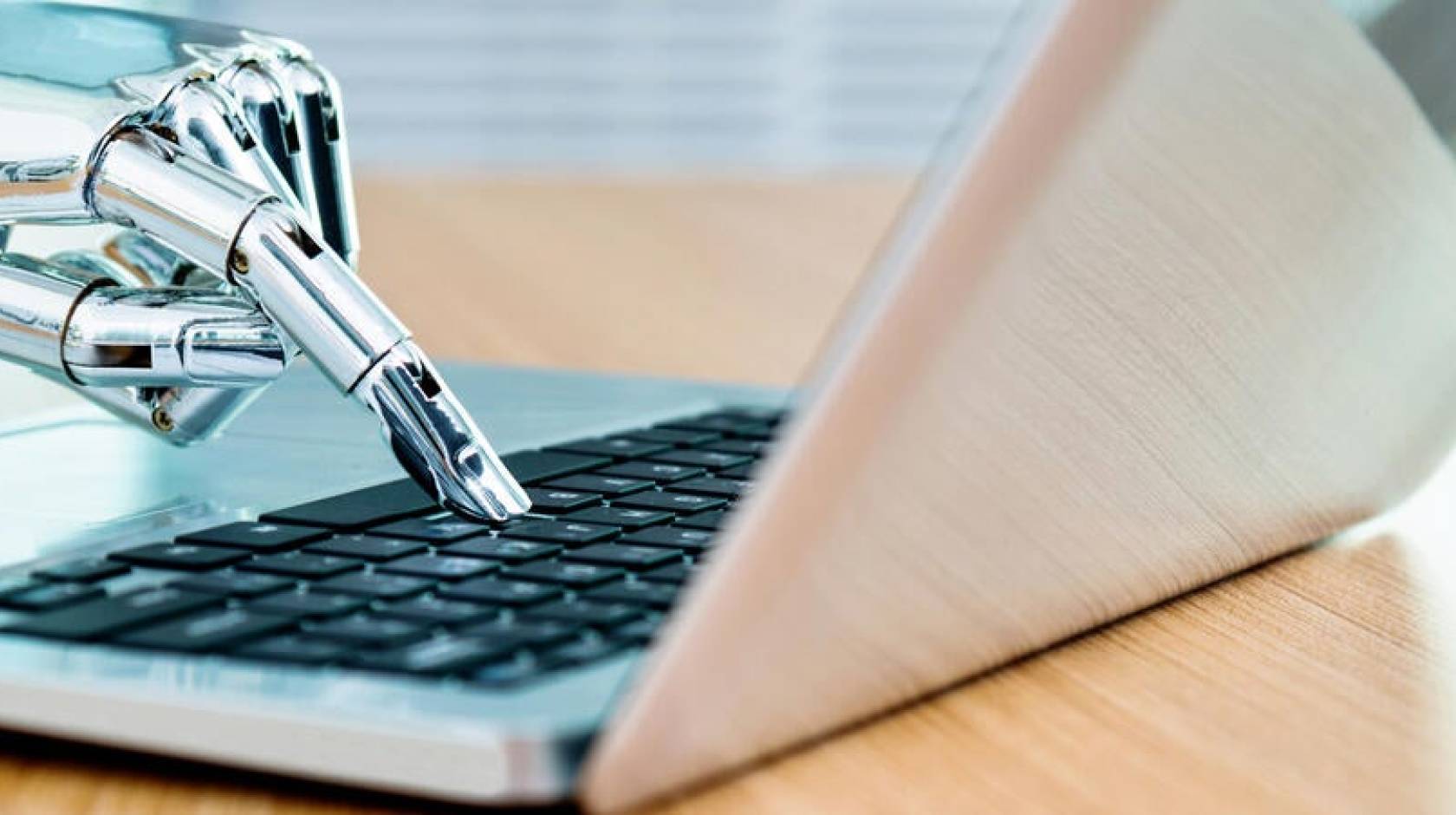 A robot hand presses a keyboard