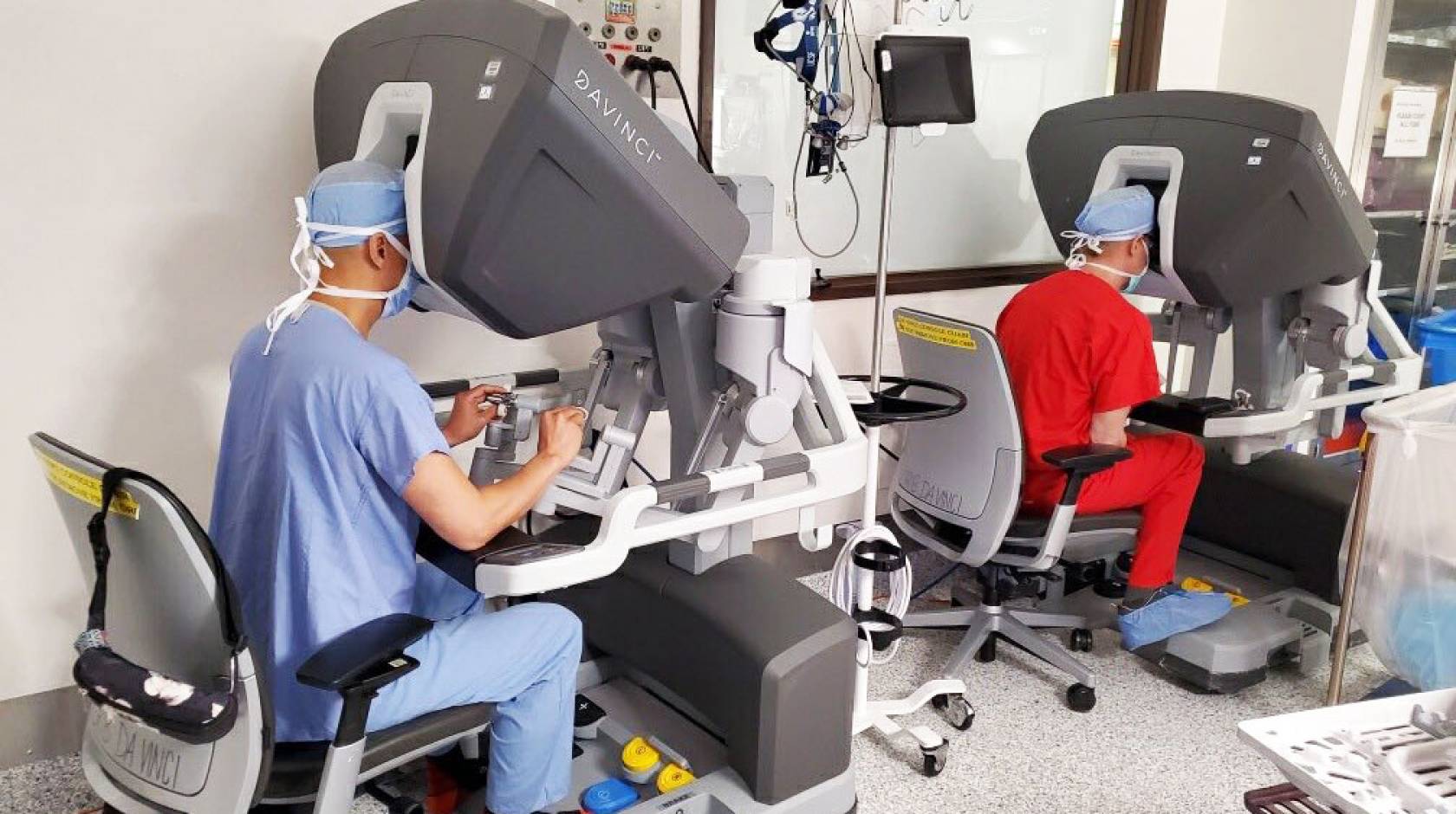 2 surgeons performing a cardiac surgery through machines
