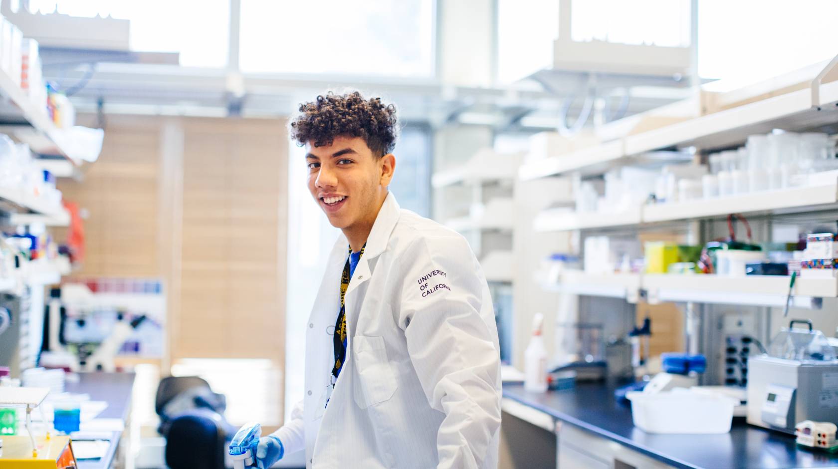 Young Black male researcher in UC lab coat