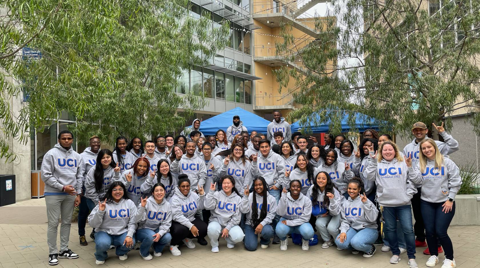 A group photo of SIEML 2023 on the UC Irvine campus, with everyone in UCI sweatshirts