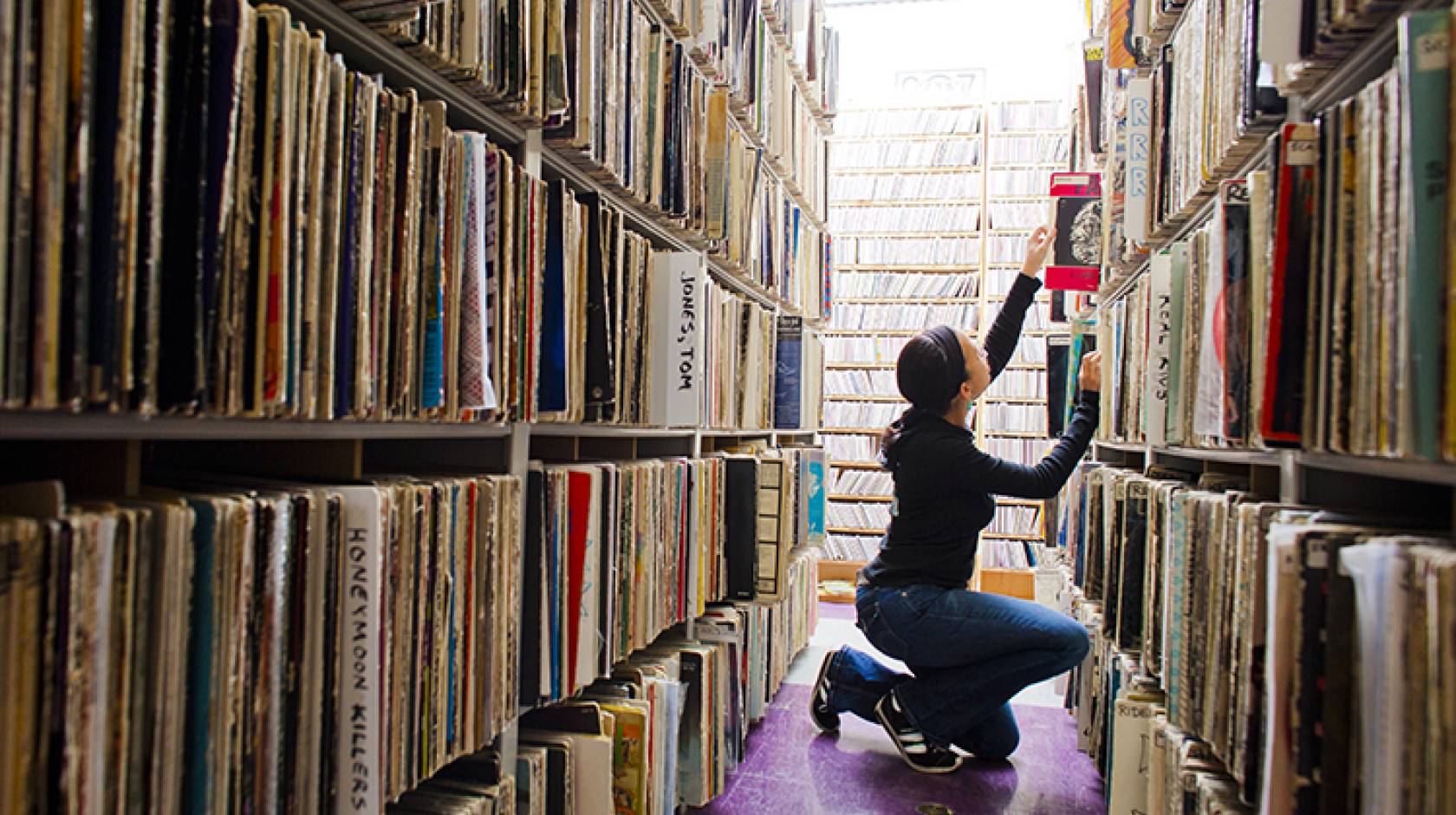 Student looks through the music archive of KALX on the UC Berkeley campus