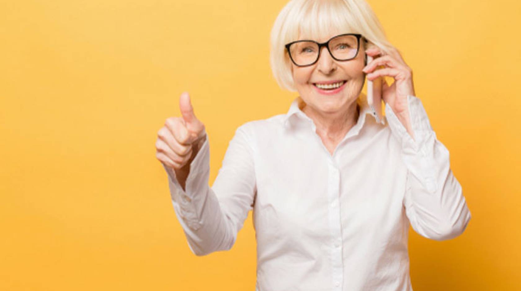 Thumbs up from an older woman who is standing