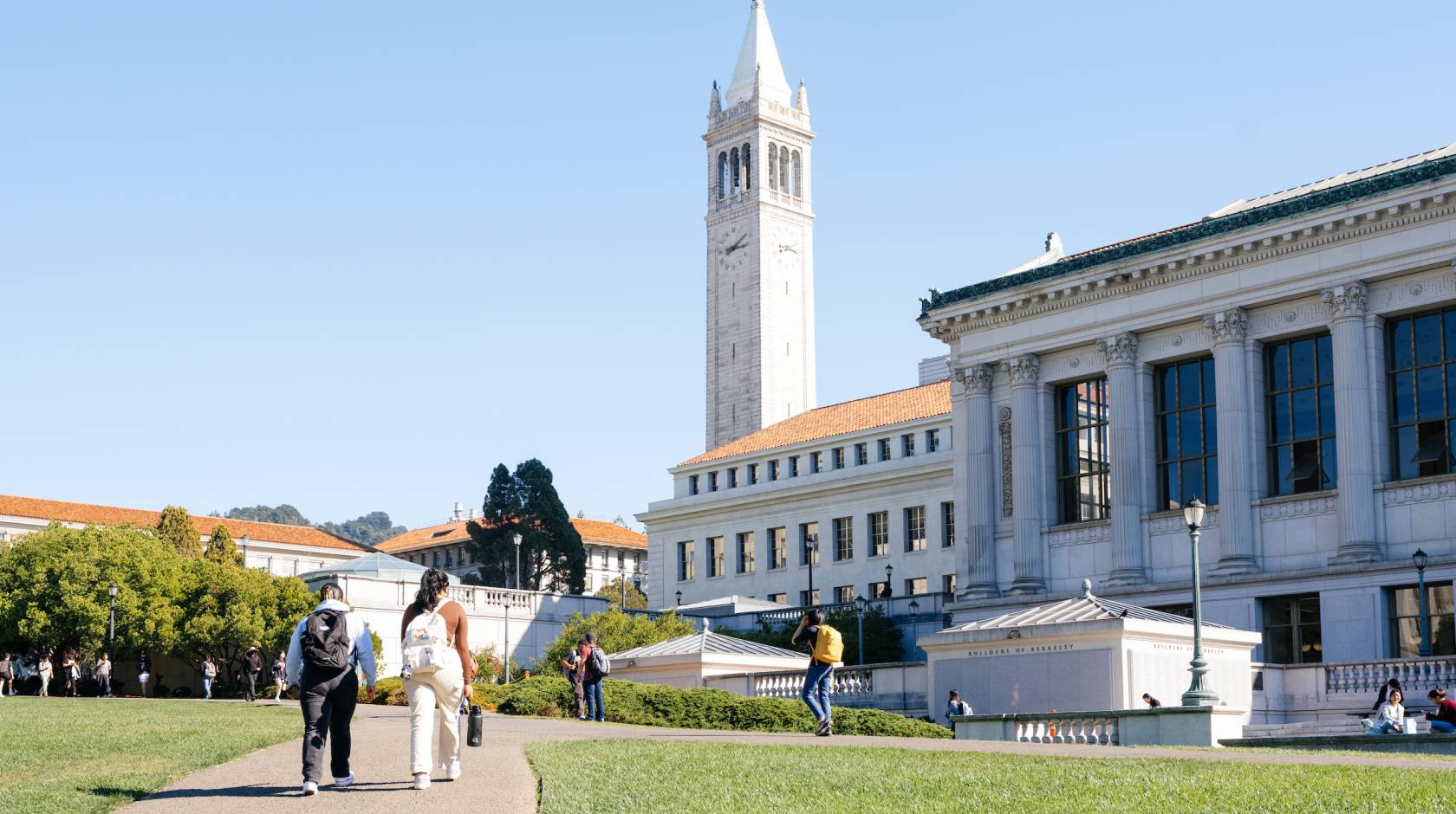 A view of students walking on the UC Berkeley campus on a clear day, Sather Tower ahead