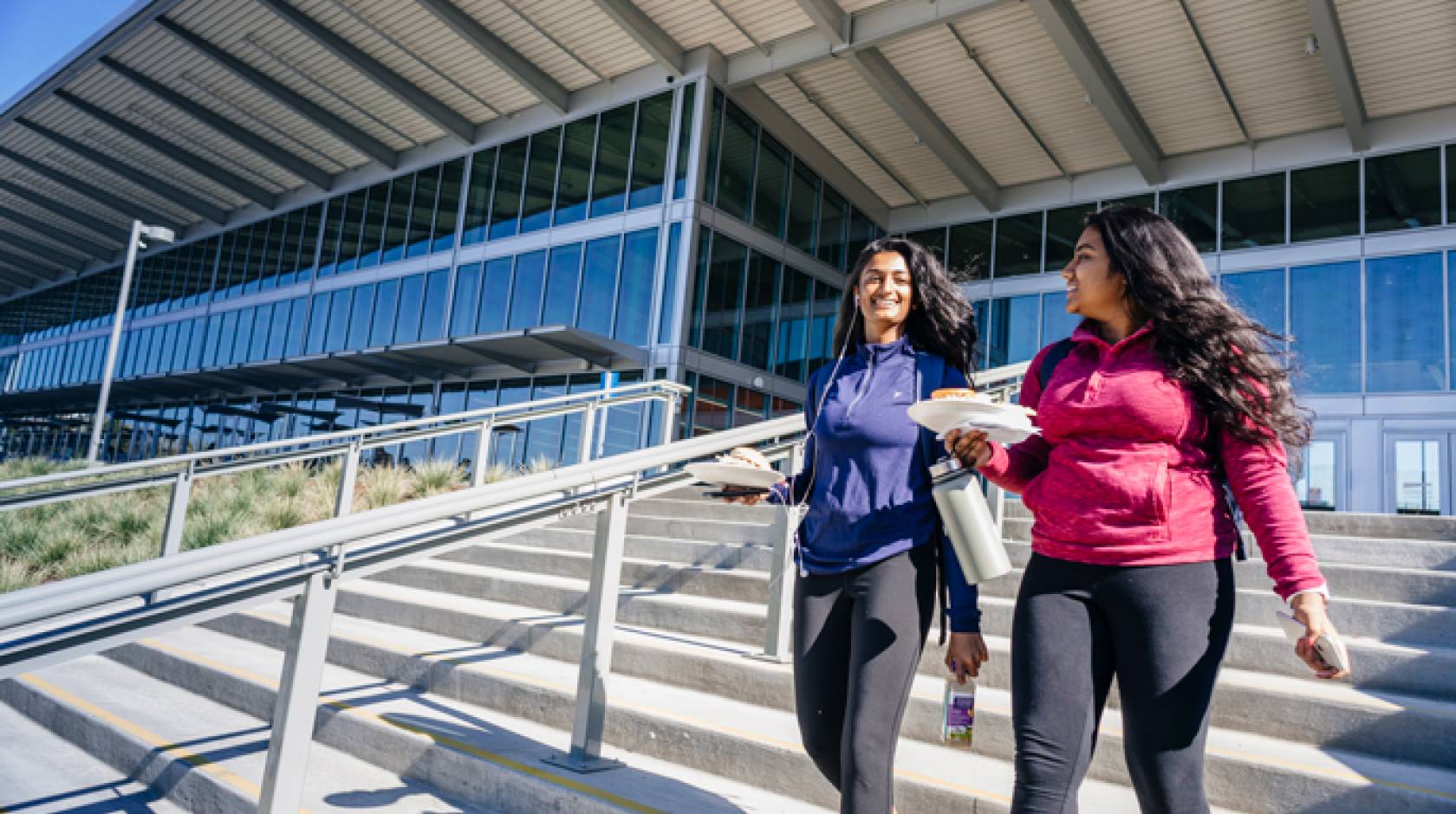 Two students walk out of the Pavilion dining center on the UC Merced campus