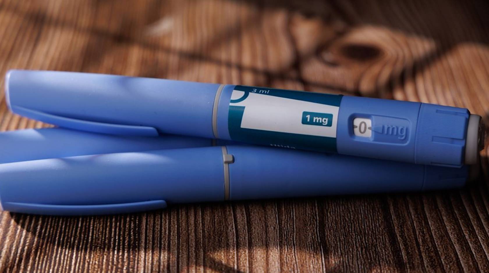 A set of three blue GLP-1 pens