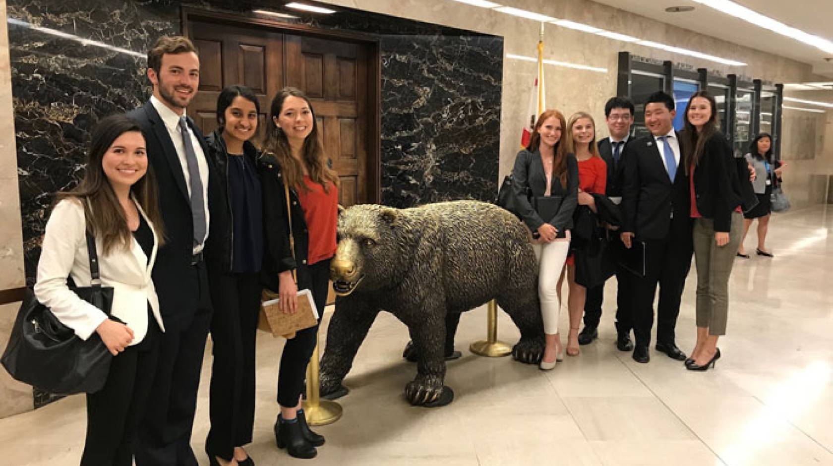 UCAN students next to bear statue in Sacramento