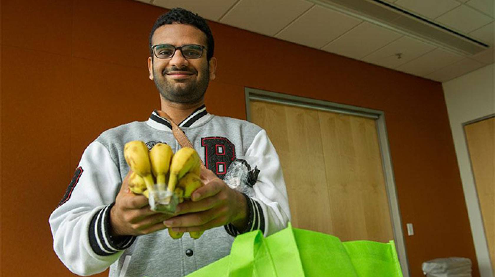 UC Davis graduate student Priyesh Shetty uses the free produce from the Fruit and Veggie Up! program to supplement his diet.